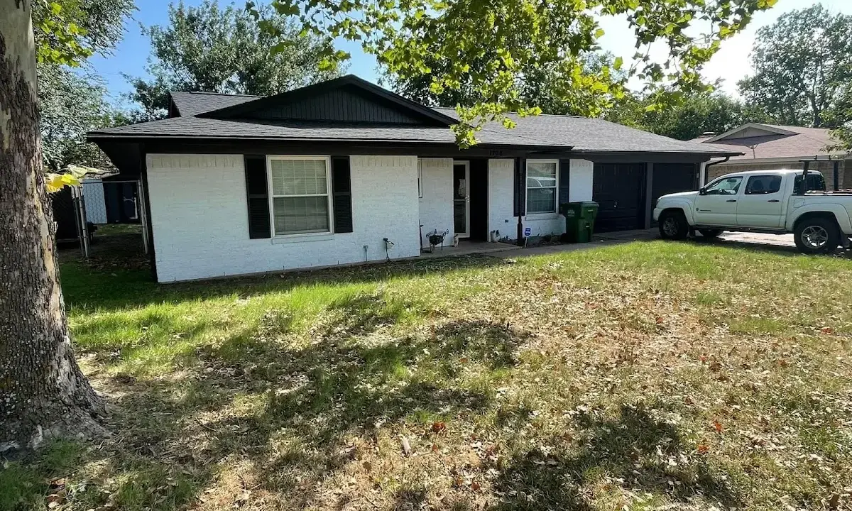 Professional roofing crew working on a residential roof in Calera